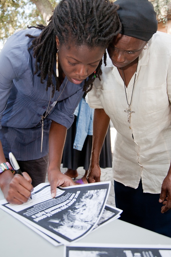 Nadege Charles, left, a parishioner at Notre Dame d'Haiti Mission in Miami and a reporter for The Miami Herald, collects information Oct. 17, during a parish revival event at Notre Dame d'Haiti, for The Miami Herald's Haiti Memorial Database project, which provides survivors a place to register love ones� names, photos, and memories.