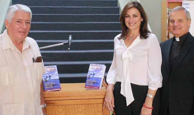 Jose Basulto, founder of Brothers to the Rescue, left, and Lily Prellezo, a south Florida Catholic and author of "Seagull One: The Amazing True Story of Brothers to the Rescue", pose with Msgr. Franklyn Casale, president of St. Thomas University, after a Hispanic heritage event on campus.