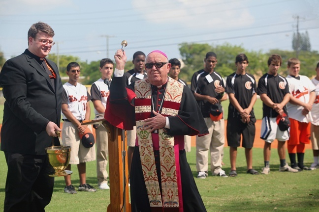 Archbishop Emeritus John C. Favalora blesses Archbishop Curley Notre Dame's new baseball field.