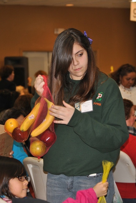 A young volunteer, Rene García, passes out treats during the "Purísima" celebration at Good Shepherd Parish in Miami.