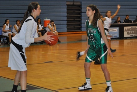 Briana Pulido, left, and the Lady Bulldogs of Archbishop Carroll High, face off against St. Brendan's Sabres.