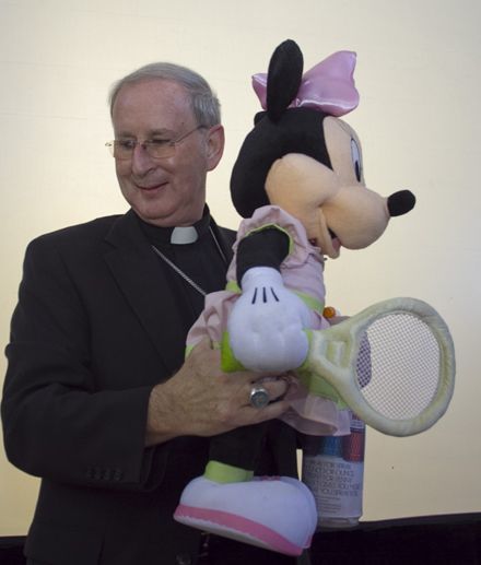 Bishop Noonan holds up a "symbol" of his new office in Orlando.