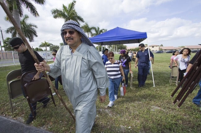 Led by Moses (Roberto Vargas) the candidates and catechumens carry their tent and chairs through "the desert."