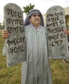 Roberto Vargas, dressed as Moses, brings the 10 Commandments down from Mount Sinai.