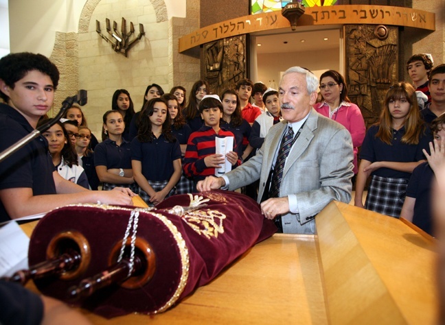 Rabbi Edwin Farber displays the Torah and explains its meaning to St. Hugh students.