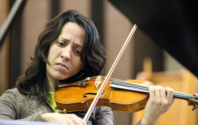 Marianna Carreras, music teacher at St. Hugh School in Coconut Grove, plays the theme from "Schindler's List" during the prayer service Jan. 19 at Beth Torah Synagogue in Aventura.