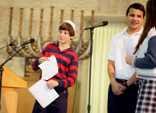 Victor Cabarrocas, 13, and other St. Hugh students sing "Sunrise, Sunset" from "Fiddler on the Roof" during their visit to Beth Torah synagogue in Aventura.
