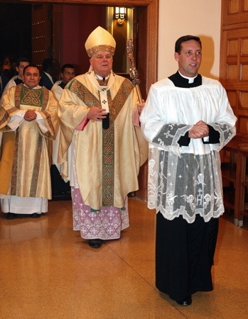 Archbishop Thomas Wenski enters into the Cathedral of St. Mary for the celebration of midnight Mass on Christmas.