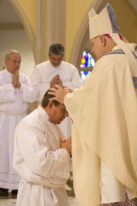 Archbishop Wenski lays hands on William Horton of St. Gregory the Great Parish in Plantation.