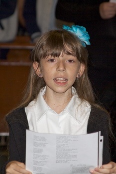 Karina Quiroga, a fourth grader at Immaculate Conception School, sings during the Mass in honor of the Virgin Mary.