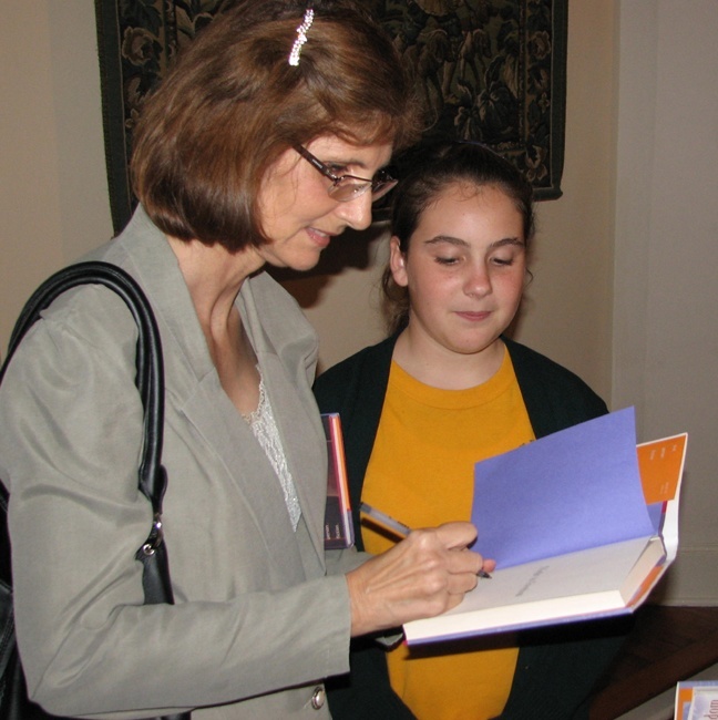 Ana Veciana-Suarez signs Laura Moran's copy of "Flight to Freedom" during her visit to St. Theresa School in Coral Gables.