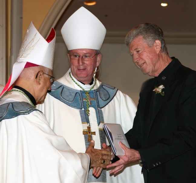 Golden jubilarian Brother Patrick Sean Moffett of the Congregation of Christian Brothers, receives a certificate of appreciation from Auxiliary Bishop John Noonan, center, and retired Auxiliary Bishop Agustín Román.