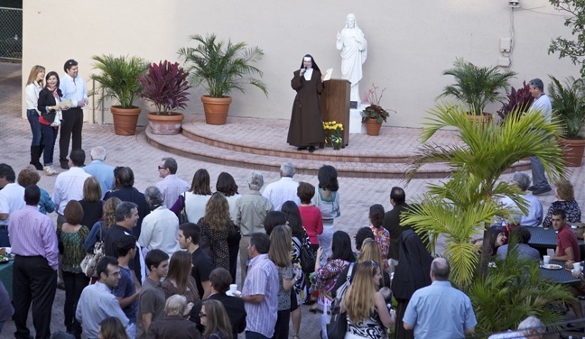 Sister Rosalie Nagy, St. Theresa School�s current principal, greets hundreds of alumni and family who gathered in the center of campus during the school�s first ever reunion March 20.