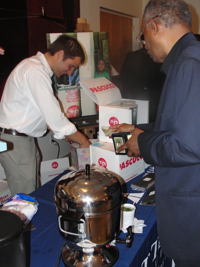 Anthony Vinciguerra, coordinator of St. Thomas University's Center for Justice and Peace, sells fair-trade coffee produced by a farmers cooperative in northwest Haiti.