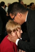 Father Giovanni Pe�a imparts his first blessing -- and a kiss -- to his mother, Luz Caicedo de Pe�a.
