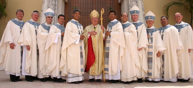 Posing for the formal photo outside St. Mary Cathedral, from left: Msgr. Michael Carruthers, rector of St. John Vianney College Seminary in Miami; Msgr. William Hennessey, vicar general; Auxiliary Bishop Felipe Estevez; newly ordained Father Armando Tolosa and Father Jesus 'Jets' Medina; Archbishop John C. Favalora; newly ordained Father Giovanni Pe�a and Father Luis Rivero; Auxiliary Bishop John Noonan; retired Auxiliary Bishop Agustin Roman; Father Roberto Garza, director of vocations; and Msgr. Keith Brennan, rector of St. Vincent de Paul Regional Seminary in Boynton Beach.