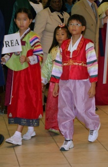 Korean children process into church for the multicultural Mass.