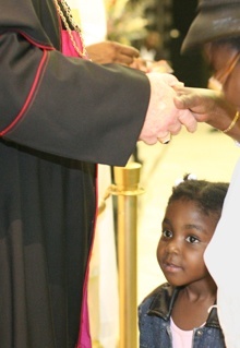 At the reception after Mass, Camilene Francois, 4, told Archbishop Wenski, "I like your dress."