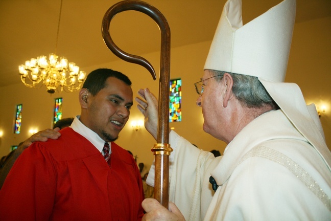 Alvaro Rivera is anointed by Auxiliary Bishop John Noonan.