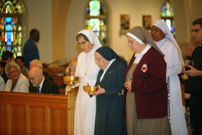 Representatives of religious communities bring up the offertory gifts during the Mass.