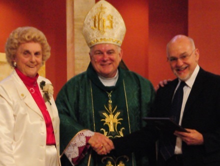 Christian Brother Richard DeMaria, right, receives the Lumen Christi (Light of Christ) award from Marjorie Wessel, president of the Catholic Educators Guild, and Archbishop Thomas Wenski.