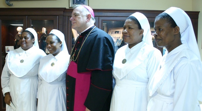 Archbishop Thomas Wenski poses for a photo with the Holy Spirit sisters from Tanzania who teach at Mary Immaculate Star of the Sea School in Key West.