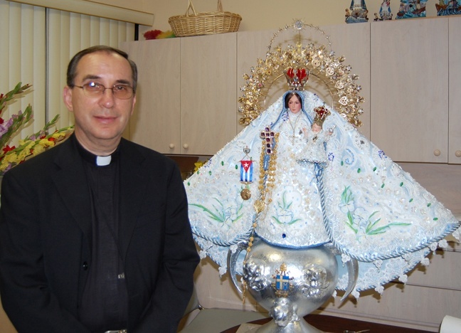Msgr. Oscar Castañeda, rector of the National Shrine of Our Lady of Charity, poses with the image of Mary that will be taken from the shrine to the University of Miami Bank United Center on Sept. 8 for the annual celebration of the feast day of Cuba's patroness.