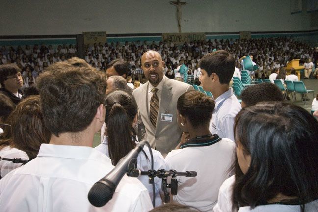 Richard Jean speaks to members of the choir and instrumentalists after the opening of school Mass Aug. 31.