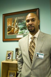 Richard Jean, the archdiocese's first Haitian principal and a product of the archdiocese's Catholic schools, poses in his new office at Archbishop McCarthy High School.