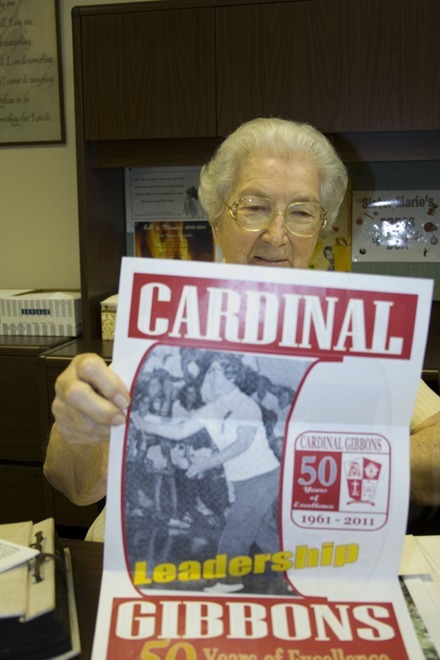The 50th anniversary poster for Cardinal Gibbons High School features a picture of Sister Marie Schramko playing volleyball with the students during an assembly. "I had a pair of jeans on me and of course the kids were just astounded," she recalled.