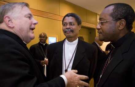 Miami Archbishop Thomas Wenski shares a funny story with two Haitian colleagues, Bishop Joseph Gontrand Décoste of Jérémie, center, and Bishop Launay Saturné of Jacmel.