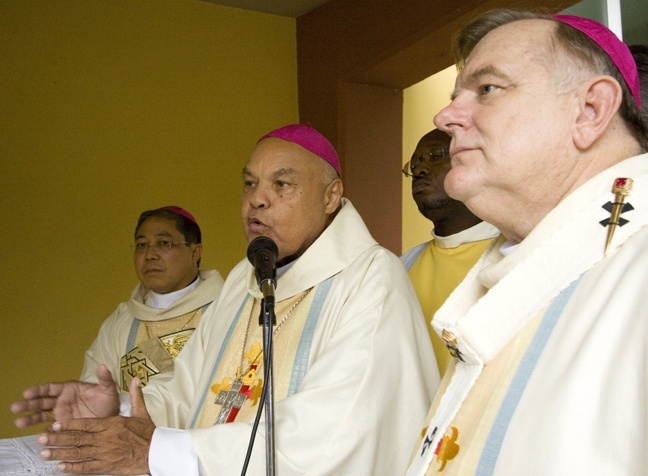 Archbishop Louis Kébreau of Cap-Haitien, president of the Haitian bishops conference, speaks as Archbishop Thomas Wenski listens at a press conference prior to Mass at Notre Dame d'Haiti Sept. 24. Behind them is Archbishop Bernardito Auza, papal nuncio to Haiti.