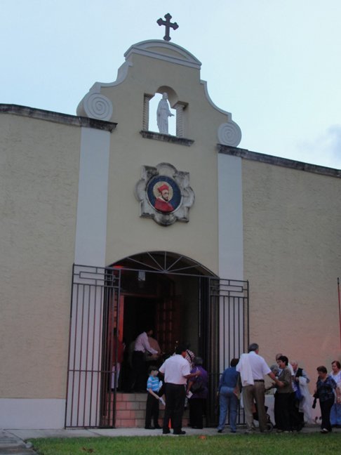Members of the community enter the church before Mass.