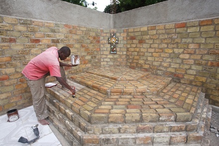 An artist puts the finishing touches on perhaps the only monument in Haiti built to honor the victims of the Jan. 12 earthquake.