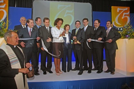Augusto Ledesma, Carlos Unanue, Peter Unanue, Tom Unanue, Florida Lt. Gov. Jennifer Carroll, Dianna Unanue, Frank Unanue, Tommy Unanue, Bob Unanue and Jorge Unanue cut the ribbon to open their new west Miami-Dade facility. Msgr. Franklyn Casale, St. Thomas University president, stands off to the side after blessing a portion of the facility.