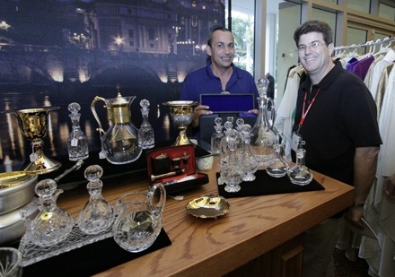 Father Francisco "Paco" Hernandez, pastor of Immaculate Conception Church in Hialeah, checks out chalices and other liturgical items with exhibitor Ramon Gonzalez of All Church Products and Services.