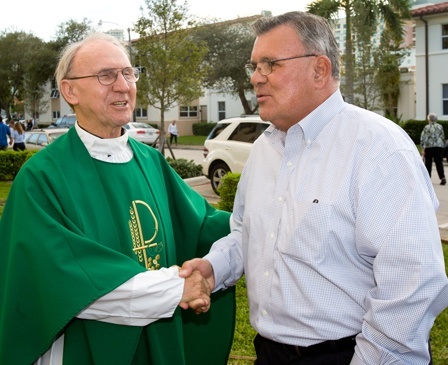 Father Jerry Singleton, pastor of St. Anthony Parish, greets Don Gale, an alumni of the class of 1955 at St. Anthony School.