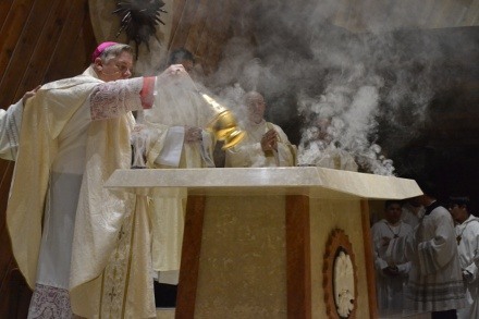 Archbishop Thomas Wenski incenses the new altar in the chapel of St. Brendan Church.