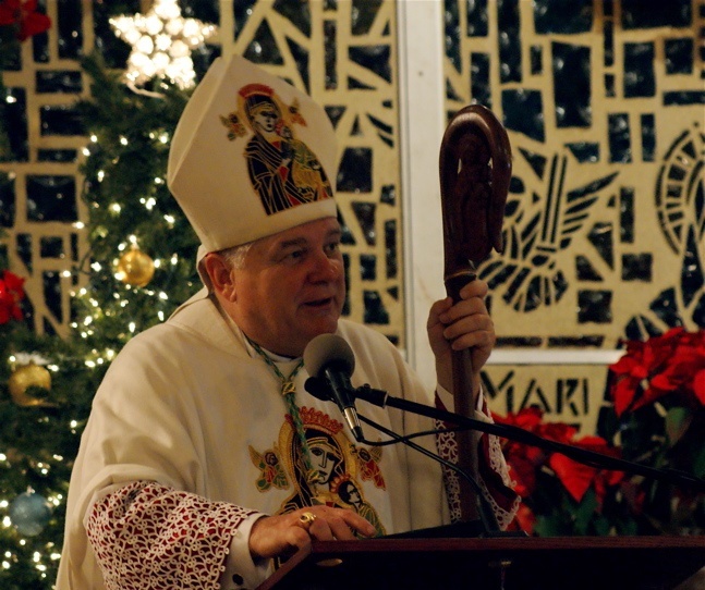 Archbishop Thomas Wenski preaches the homily during the midnight Mass at Notre Dame d’ Haiti Mission celebrating the New Year.