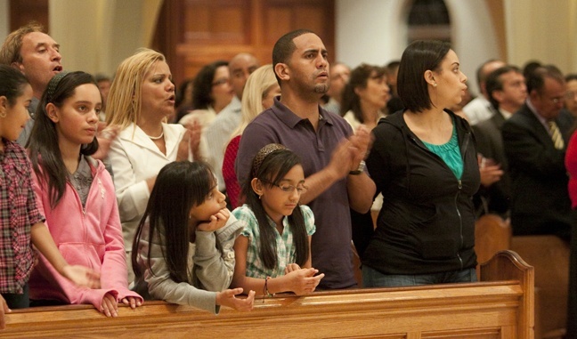 The German family, including dad Angel David, mom Elynes, and daughters Pamela, Kayla and Angelica, take part in the Mass. They are members of a Neocatechumenal community in Holy Cross Parish, Orlando.