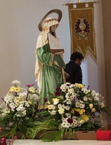 The statue of St. Cecilia is prominently displayed on the altar.
