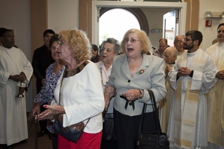 St. Cecilia parishioners accompany the image of their patroness into the church.