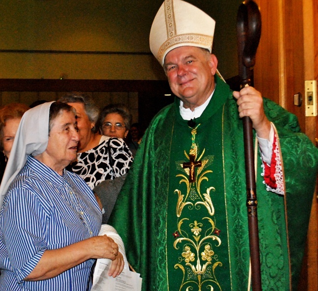 Archbishop Wenski speaks with Claretian Sister Carmen Alvarez, who was present at his first Mass as a priest 35 years ago. During Mass, he introduced Sister Alvarez as one of his oldest - in longevity of time, not age - friends in the archdiocese.