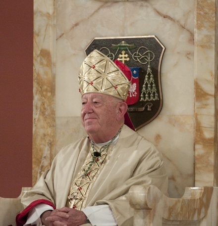 Archbishop John C. Favalora sits in the cathedra, a symbol of a bishop's authority, during the Mass.