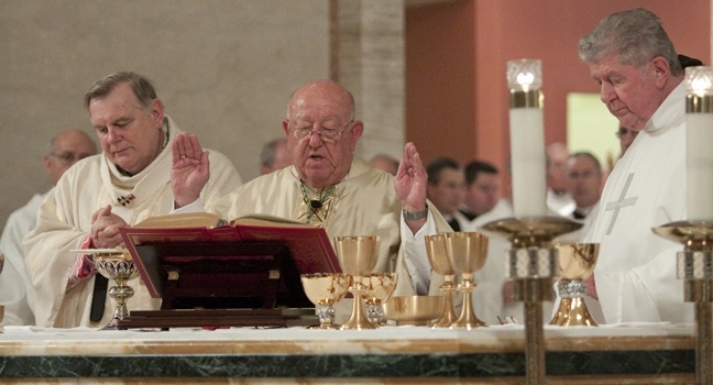 Archbishop John C. Favalora recites the eucharistic prayer. At left is Archbishop Thomas Wenski and at right is Archbishop Favalora's Rome classmate, also celebrating 50 years in the priesthood, Msgr. William Hennessey.