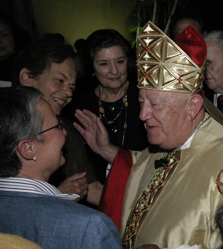 Well-wishers gather around Archbishop John C. Favalora to congratulate him after Mass.