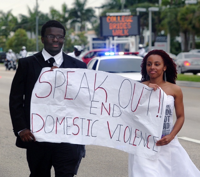 Two marchers arriving at 151st St., North Miami, where they would turn around and march back to Barry University, participate in the walk wearing a bridal gown and tuxedo to bring awareness to the evils of domestic and dating violence.