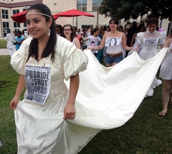 Carolina Martinez, a Barry student, waits for marchers to leave Barry University for the 7.5 mile walk.