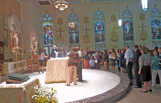 A long line of friends and well-wishers waits to receive a blessing from Father Thomas Griffin at the end of Mass.