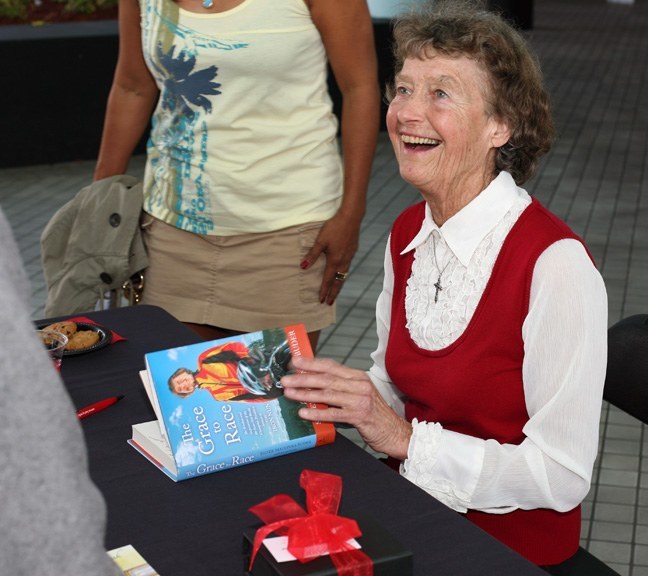 Sister Madonna Buder smiles at an admirer while autographing copies of her book at Barry University.